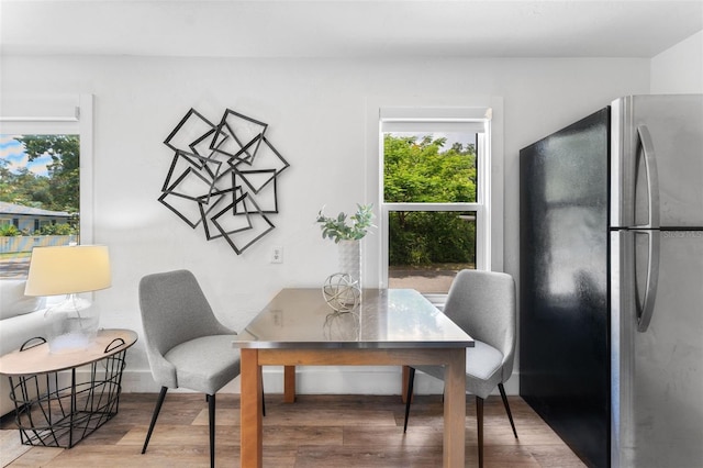 dining space with hardwood / wood-style floors