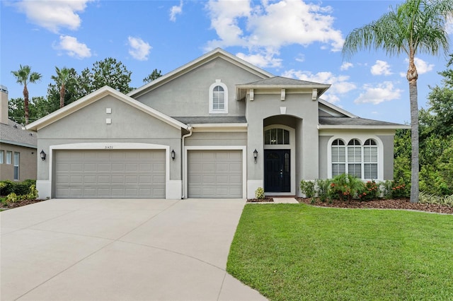 view of front of property featuring a front yard and a garage