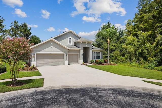 view of front of property with a garage and a front lawn