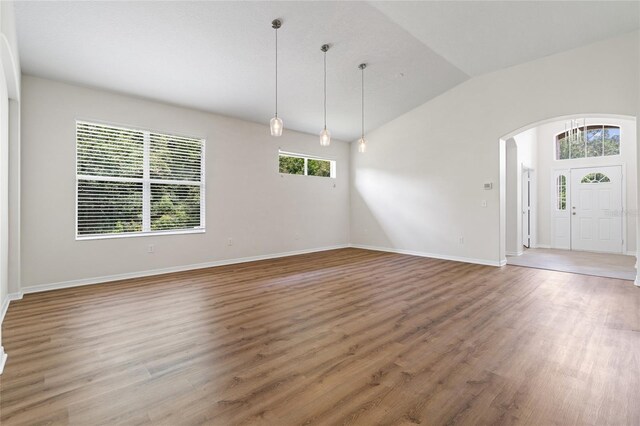 interior space featuring hardwood / wood-style flooring and vaulted ceiling