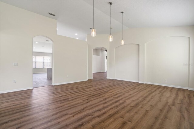 unfurnished room with high vaulted ceiling and wood-type flooring