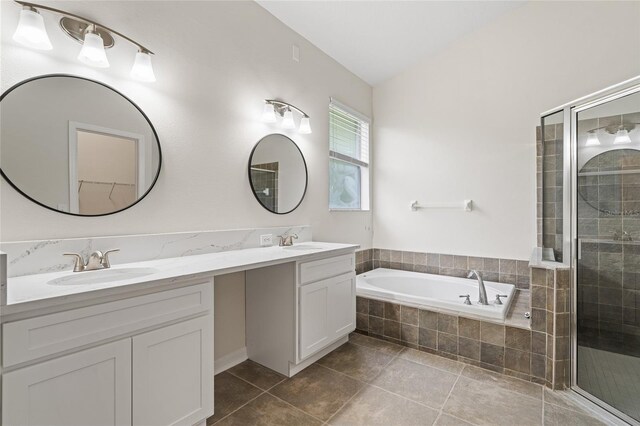 bathroom with tile patterned flooring, lofted ceiling, separate shower and tub, and dual bowl vanity