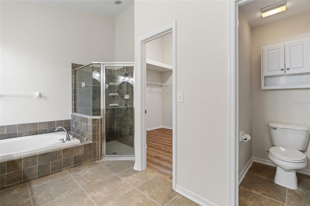 bathroom with toilet, separate shower and tub, and wood-type flooring