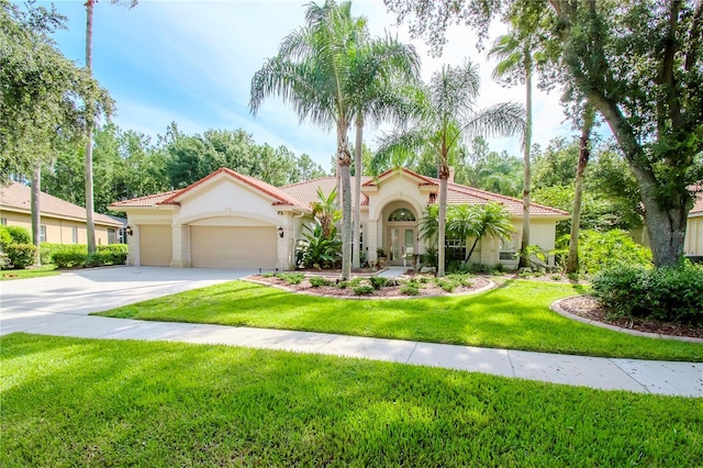 mediterranean / spanish house with a garage and a front yard