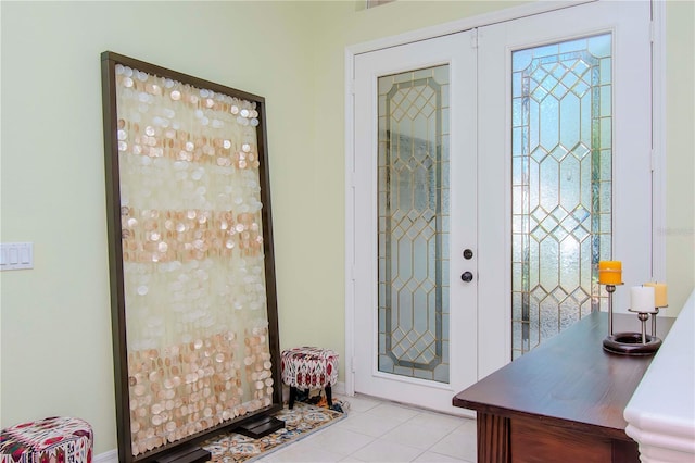 foyer featuring french doors and light tile patterned floors