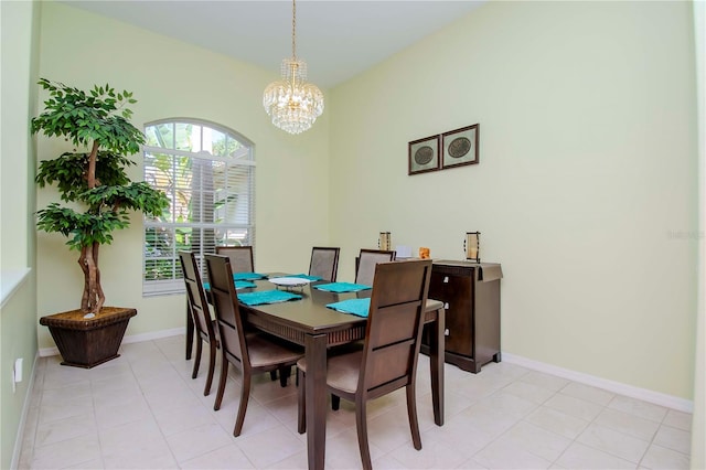 tiled dining area featuring a chandelier