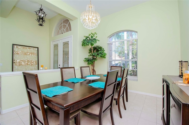 dining area featuring french doors, light tile patterned floors, and an inviting chandelier