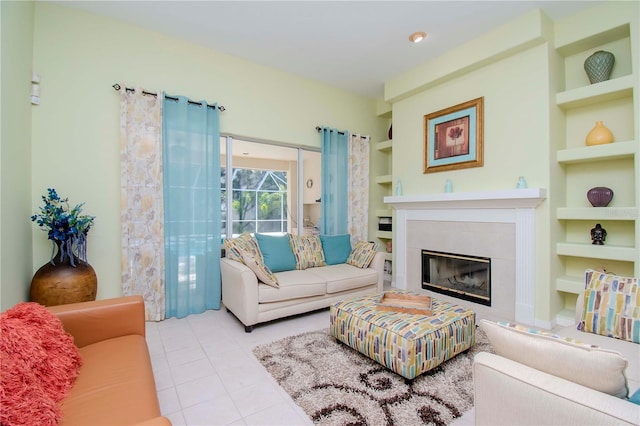 tiled living room with a tile fireplace and built in features