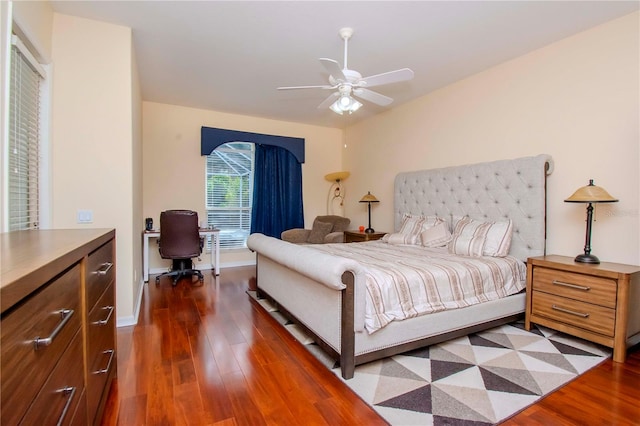 bedroom with dark hardwood / wood-style floors and ceiling fan