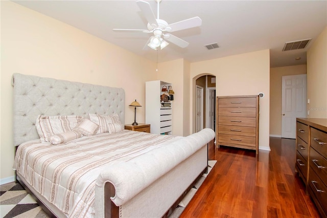 bedroom with ceiling fan, dark hardwood / wood-style flooring, and a closet