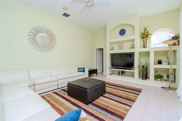 tiled living room featuring built in features and ceiling fan