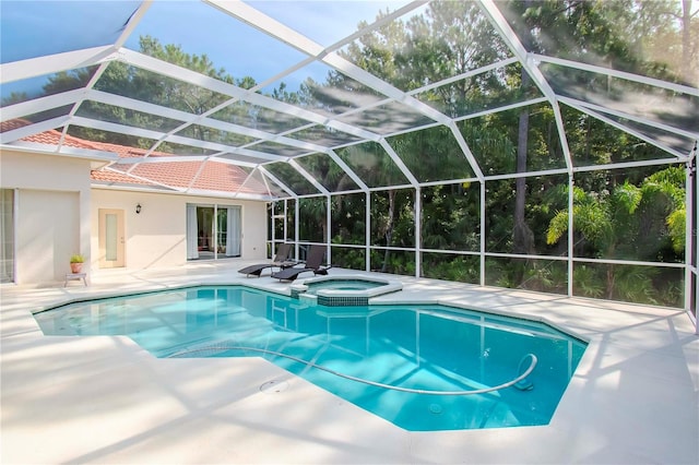 view of pool featuring an in ground hot tub, a patio, and a lanai