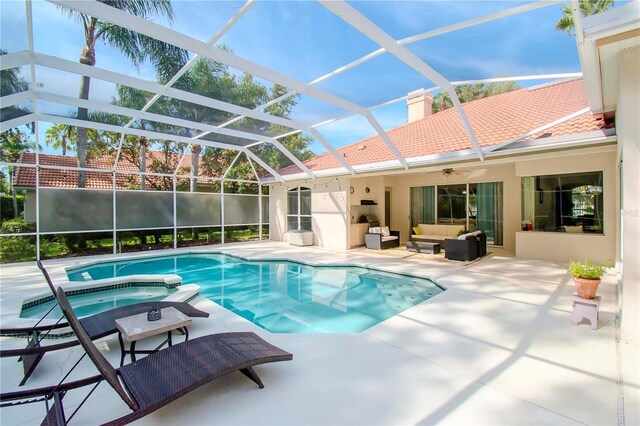 view of pool featuring a patio, an in ground hot tub, an outdoor hangout area, and glass enclosure