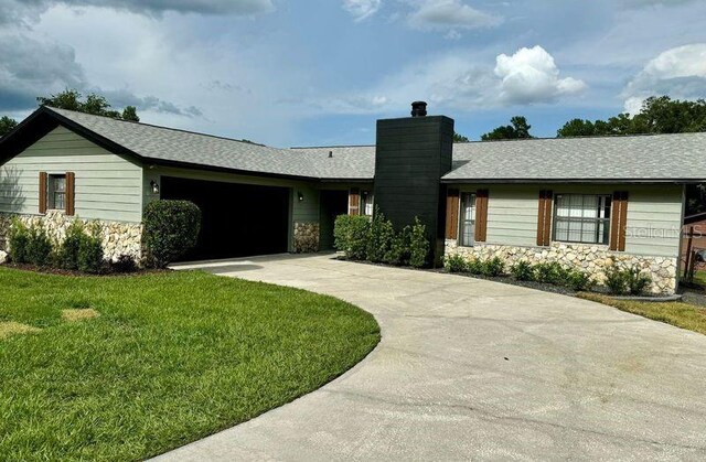 ranch-style house with a front lawn and a garage