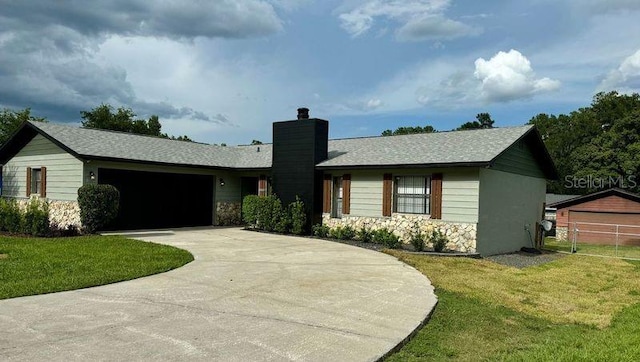 ranch-style home featuring a garage and a front yard