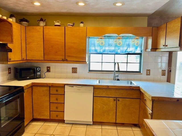 kitchen featuring sink, decorative backsplash, wall chimney exhaust hood, and white dishwasher