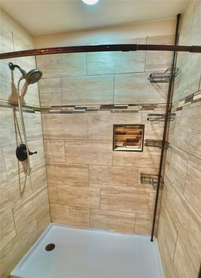 bathroom with a tile shower