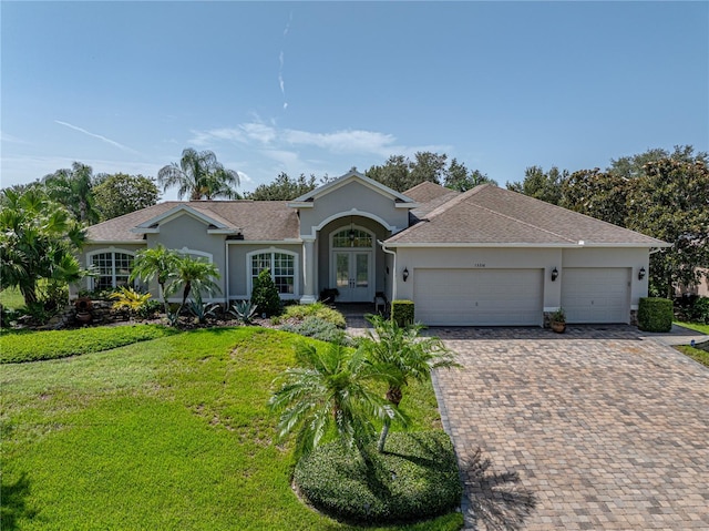 single story home featuring a front yard and a garage