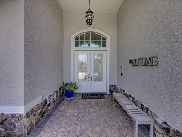 view of exterior entry featuring french doors