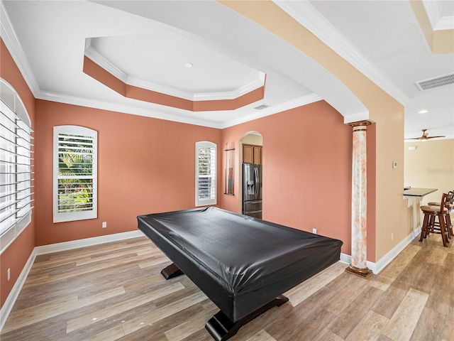 rec room featuring light hardwood / wood-style floors, a healthy amount of sunlight, decorative columns, and crown molding