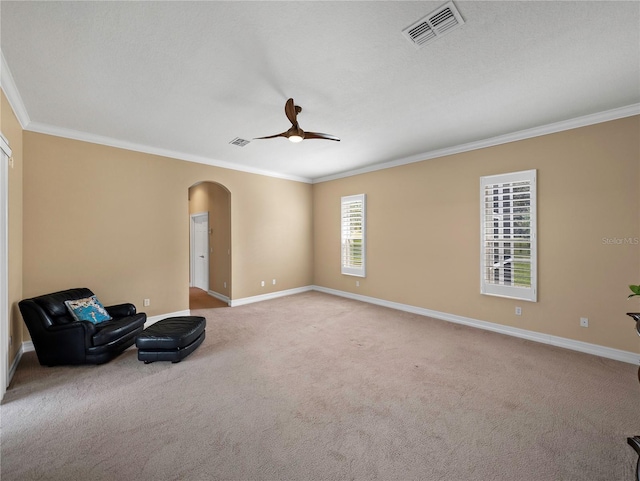 unfurnished room featuring crown molding, light colored carpet, and ceiling fan