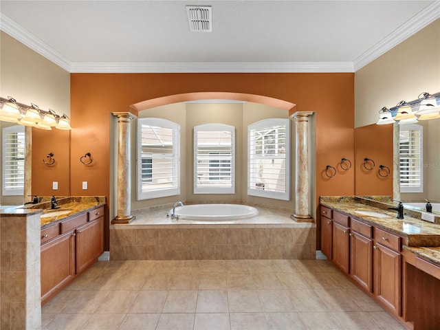 bathroom featuring decorative columns, tile patterned floors, tiled tub, vanity, and ornamental molding