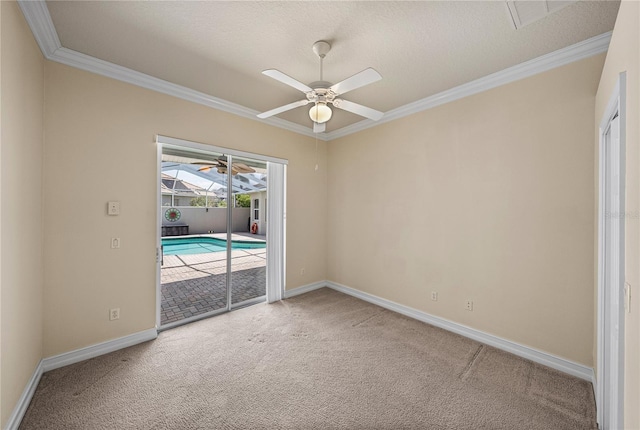 spare room featuring carpet, crown molding, a textured ceiling, and ceiling fan