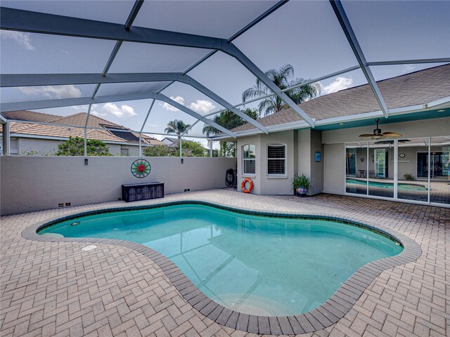 view of pool featuring a patio area, a lanai, and ceiling fan