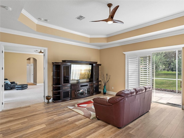 living room featuring crown molding and light wood-type flooring