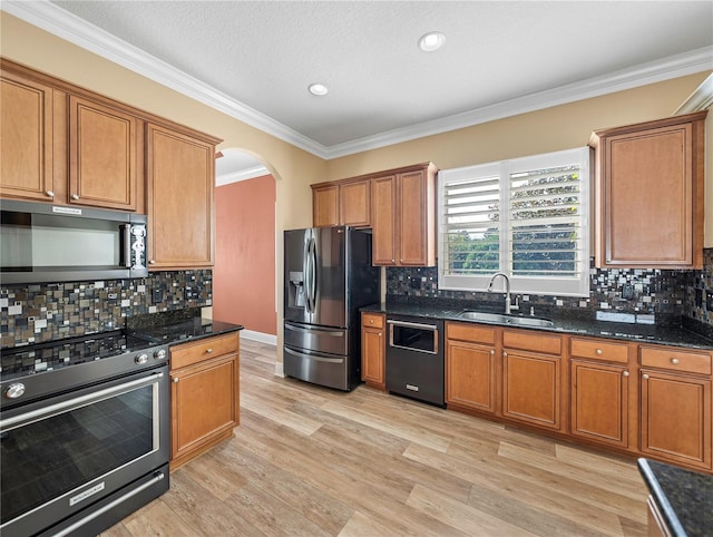 kitchen featuring appliances with stainless steel finishes, sink, and decorative backsplash