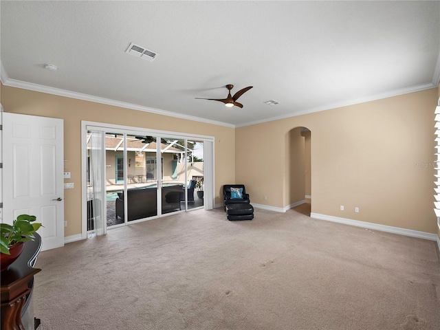 unfurnished living room with ornamental molding, light colored carpet, and ceiling fan