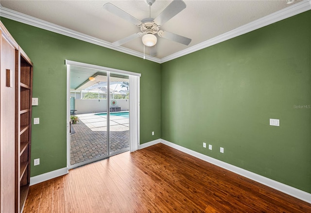 spare room featuring ornamental molding, hardwood / wood-style floors, and ceiling fan