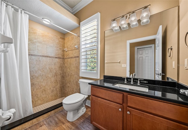 bathroom featuring hardwood / wood-style flooring, toilet, ornamental molding, curtained shower, and vanity