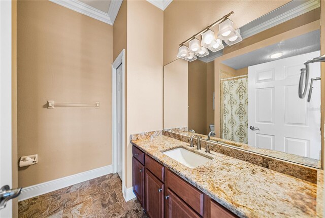 bathroom with vanity, ornamental molding, and toilet