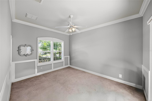 carpeted spare room with ornamental molding and ceiling fan