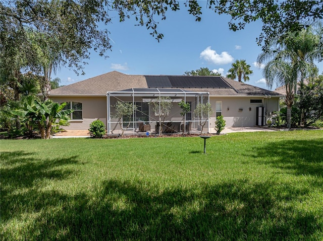 rear view of house with a lanai and a lawn