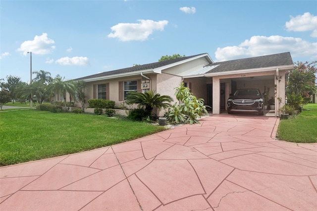 ranch-style home with a carport, driveway, a front lawn, and stucco siding