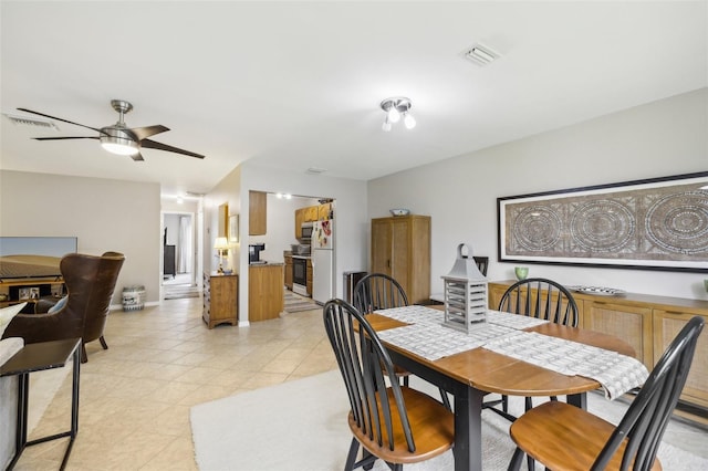 tiled dining room featuring ceiling fan