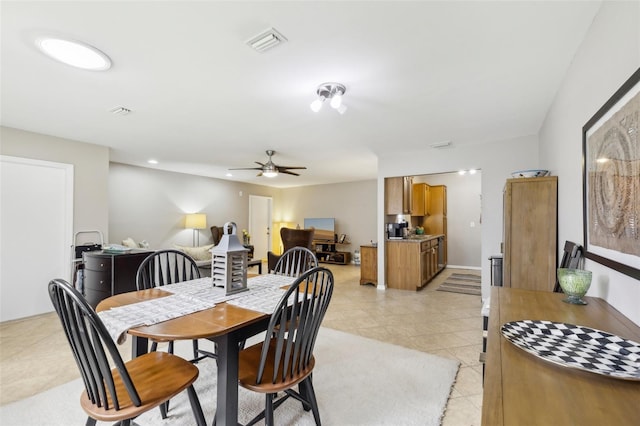 dining space featuring light tile patterned floors and ceiling fan