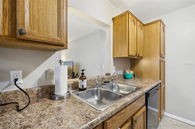 kitchen with light tile patterned floors, black dishwasher, brown cabinets, light countertops, and a sink