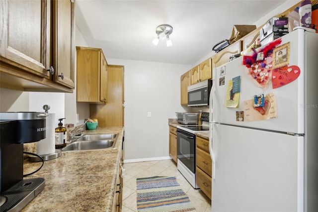 kitchen featuring sink, white appliances, and light tile patterned floors