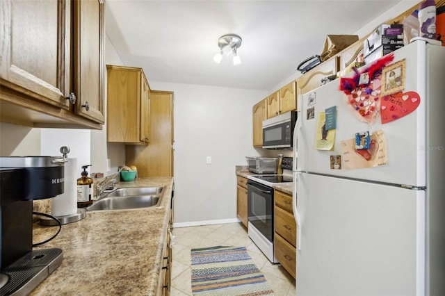 kitchen featuring light tile patterned flooring, a sink, electric stove, light countertops, and freestanding refrigerator