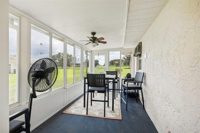 sunroom featuring ceiling fan