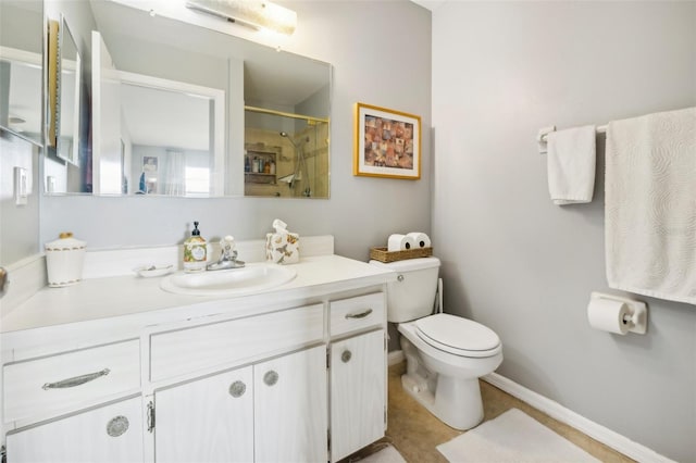 bathroom with a shower, baseboards, vanity, and toilet