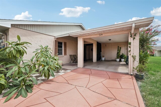 back of property featuring stucco siding