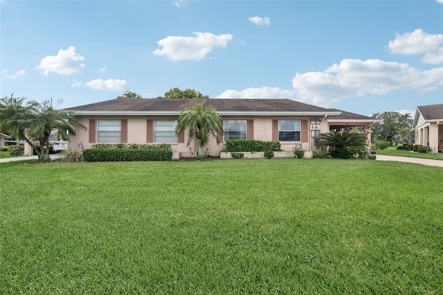 ranch-style home featuring a front lawn and stucco siding