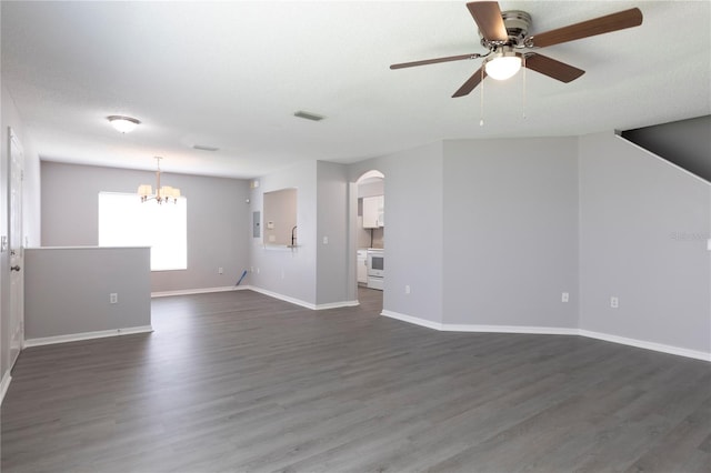 unfurnished living room with ceiling fan with notable chandelier, dark wood-type flooring, and a textured ceiling