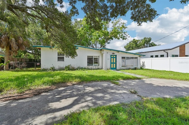 ranch-style home with a front lawn