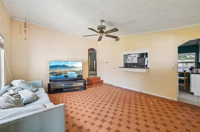 tiled living room with ceiling fan