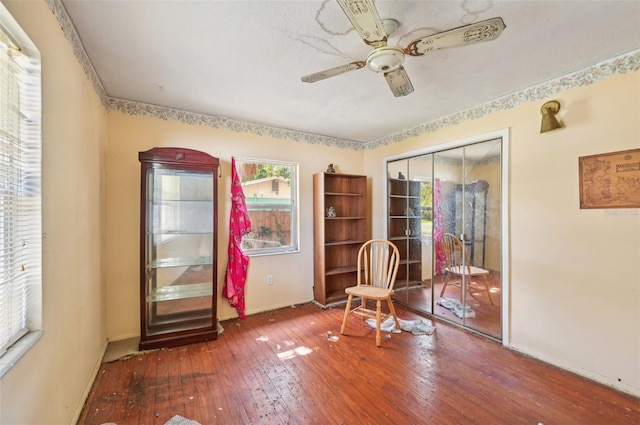 interior space with wood-type flooring and ceiling fan